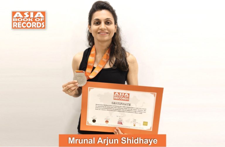 Longest duration to perform the plank pose with additional weight by a female Image of Mrunal Arjun Shindhaye, Longest duration to perform the plank pose with additional weight by a female.
